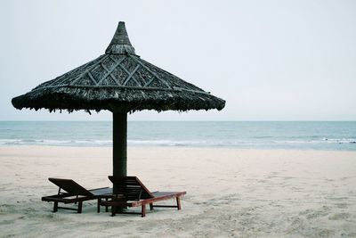 Lifeguard hut on beach against clear sky