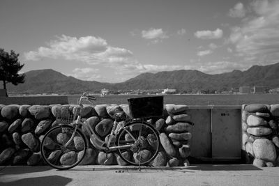 Bicycles on retaining wall against mountains