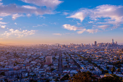 Aerial view of cityscape against sky during sunset