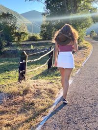 Rear view of girl  with hat on field