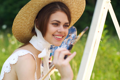 Portrait of young woman wearing hat