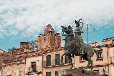 Low angle view of statue against cloudy sky