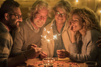Smiling family celebrating at night