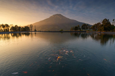 Scenic view of lake against sky during sunset