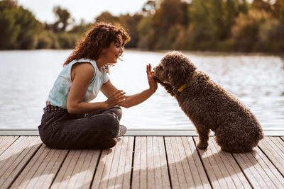 Side view of woman with dogs on hardwood floor