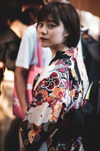 Portrait of young woman in traditional clothing standing outdoors