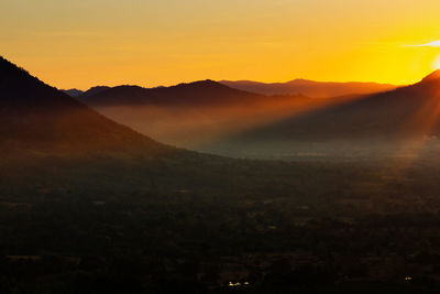 Scenic view of silhouette mountains against sky during sunset