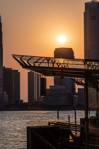 Buildings in city at sunset