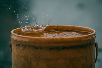Rain water drop falling to the pail in heavy rain day