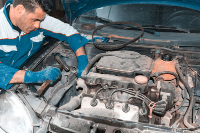 Man repairing car engine