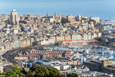 High angle view of harbor amidst cityscape during sunny day