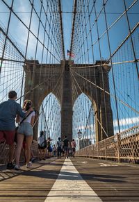 People walking on footbridge in city