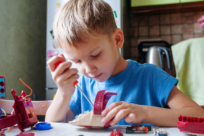 Boy playing with toy at home