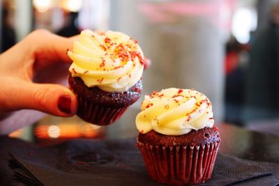 Close-up of woman hand holding cupcake