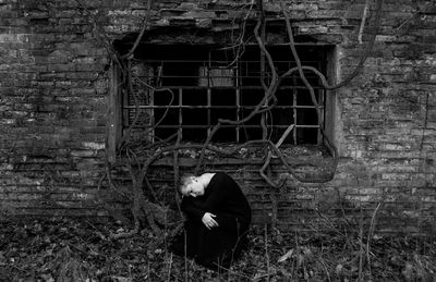 Man standing against old building