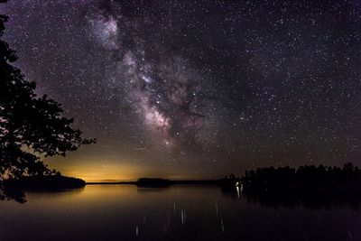 Scenic view of lake against sky at night