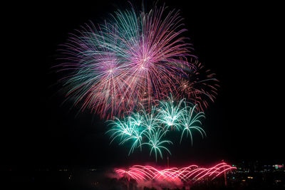 Low angle view of firework display at night