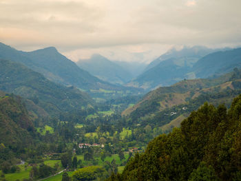 Scenic view of valley and mountains against sky