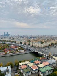 High angle view of river amidst buildings in city against sky
