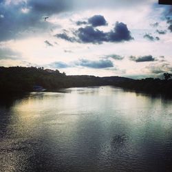 Scenic view of lake against cloudy sky