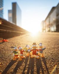 Stuffed toy in city against sky