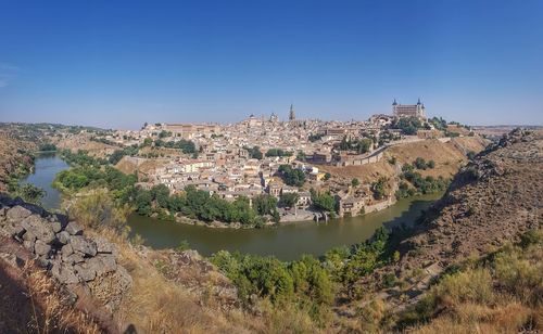 Panoramic shot of buildings against clear blue sky