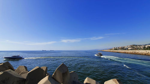 Scenic view of sea against blue sky