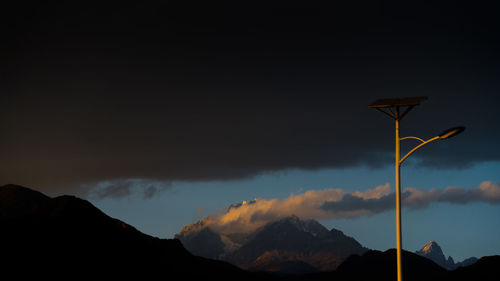 Low angle view of silhouette mountains against sky during sunset