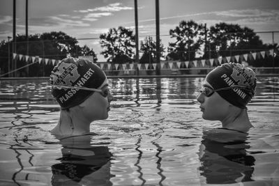 Rear view of man and woman swimming pool