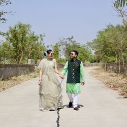 Full length portrait of woman walking on road