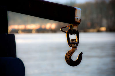 Close-up of chain on sea against sky