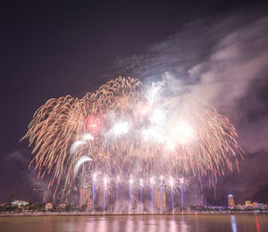 Low angle view of firework display at night