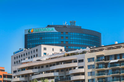 Low angle view of modern building against blue sky