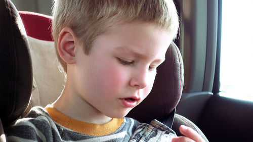 Close-up of boy sitting in car