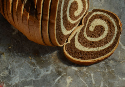 High angle view of sliced marble rye bread on table