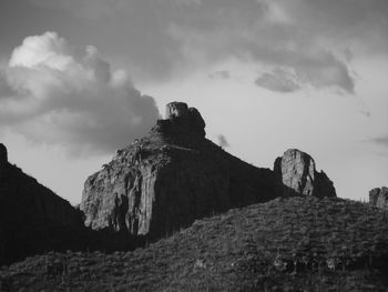 Low angle view of rock formations against sky