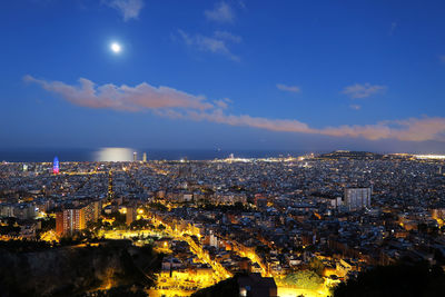 Illuminated cityscape against sky at night