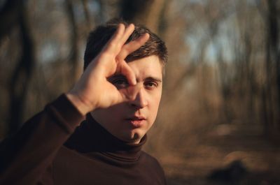 Portrait of man gesturing in forest