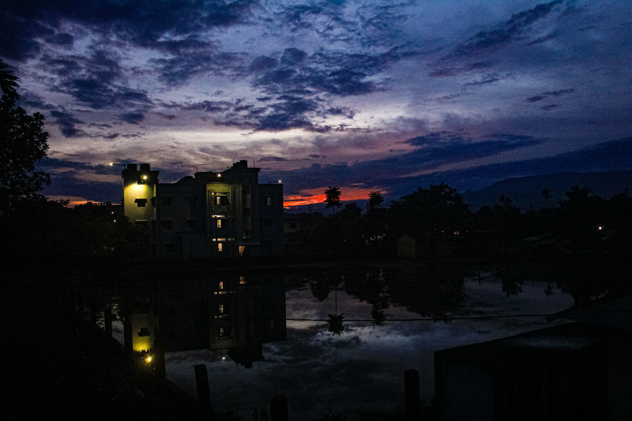 architecture, darkness, evening, sky, dusk, night, built structure, building exterior, city, cloud, illuminated, sunset, nature, building, reflection, light, no people, water, cityscape, outdoors, travel destinations, dark, street