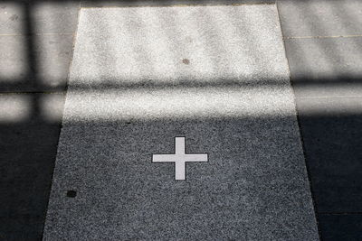 High angle view of arrow sign on road