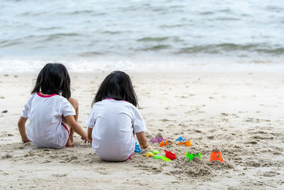 Rear view of kids on beach