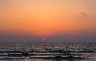 Scenic view of sea against romantic sky at sunset