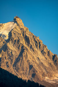 Scenic view of mountains against clear blue sky