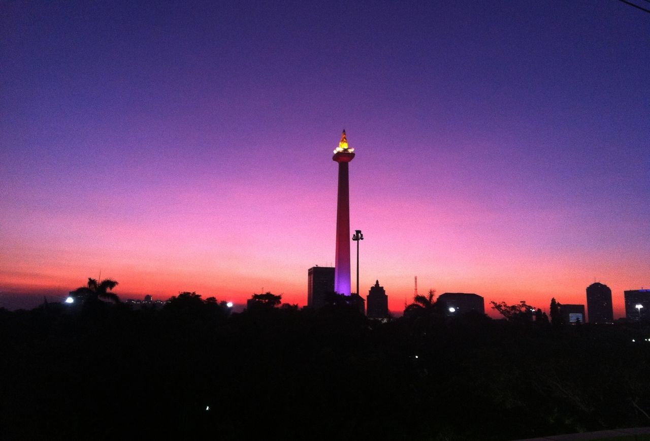 building exterior, architecture, built structure, tower, city, tall - high, sunset, communications tower, silhouette, illuminated, skyscraper, sky, capital cities, dusk, spire, travel destinations, copy space, communication, low angle view, international landmark