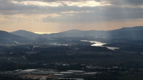 Aerial view of city against sky during sunset