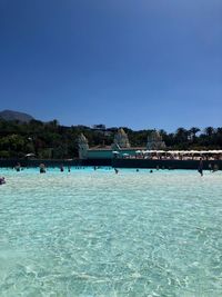 Scenic view of swimming pool against clear blue sky