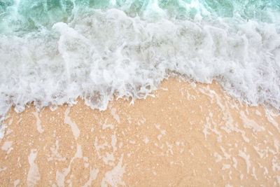 High angle view of waves splashing on shore
