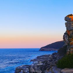 Scenic view of sea against clear sky during sunset