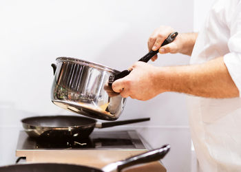 Midsection of man preparing food in kitchen