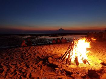 Scenic view of beach against sky at night